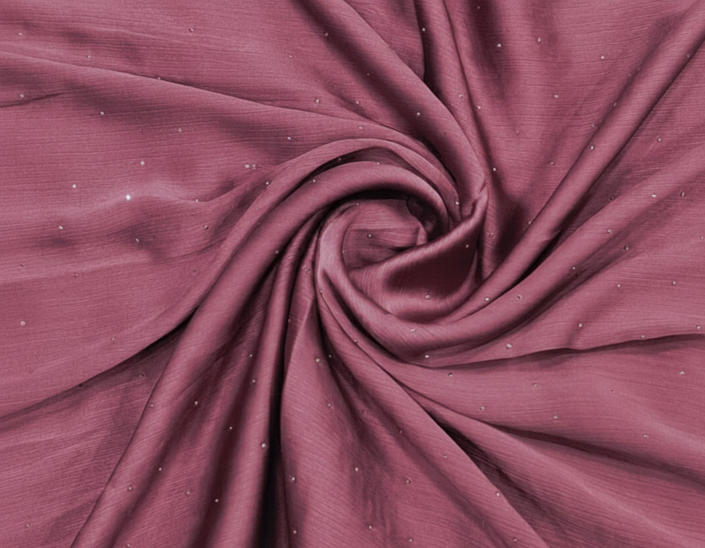 Close-up of maroon fabric with a swirl pattern