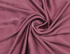 Close-up of maroon fabric with a swirl pattern