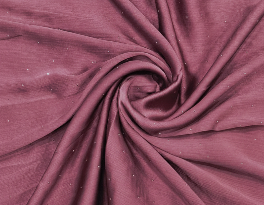 Close-up of maroon fabric with a swirl pattern