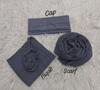 Set of dark gray cap, niqab, and scarf on a textured light gray surface.